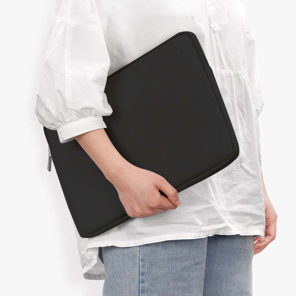 Picture of a person holding laptop inside sleeve